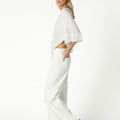 RAW ASYMMETRICAL EMBROIDERED TOP